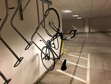 a bicycle parked in a bike rack in a basement