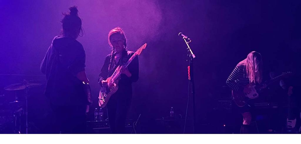 Live rock music - a band playing on stage with dim lighting